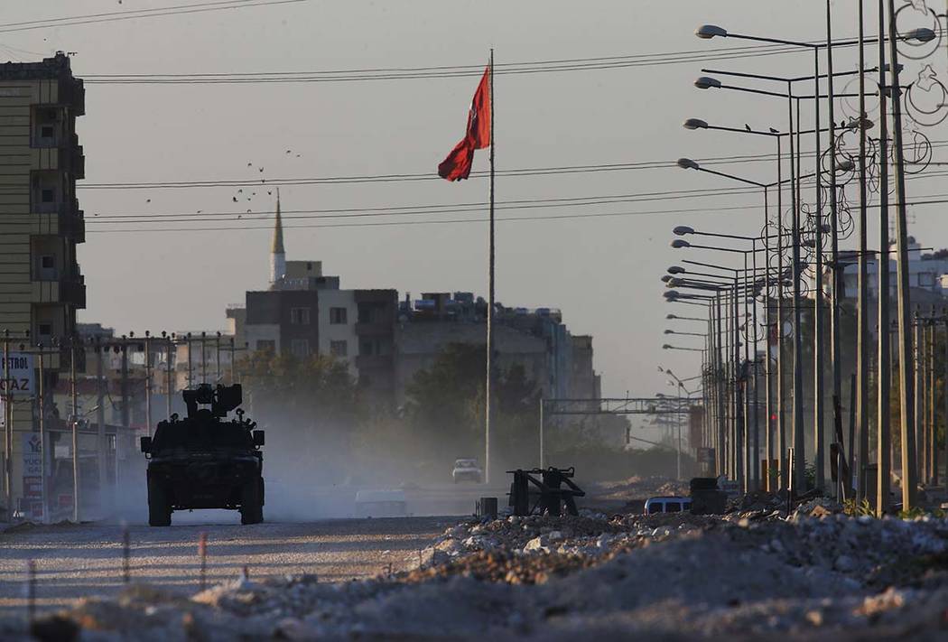 A Turkish police armored vehicle patrols the town of Akcakale, Sanliurfa province, southeastern ...