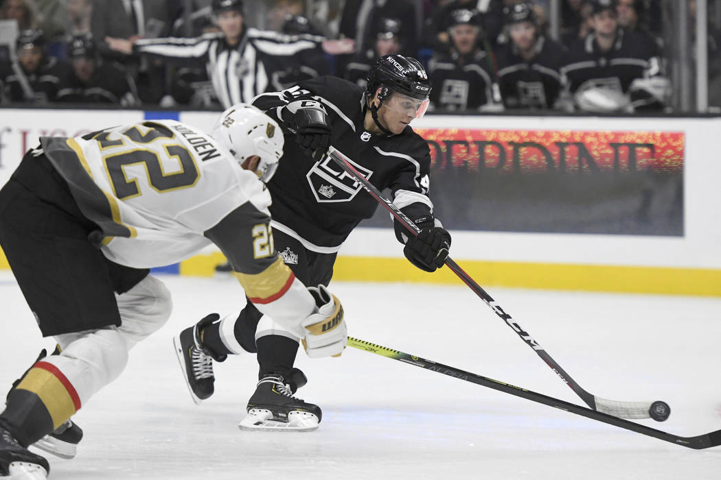 Los Angeles Kings center Blake Lizotte shoots as Vegas Golden Knights defenseman Nick Holden (2 ...