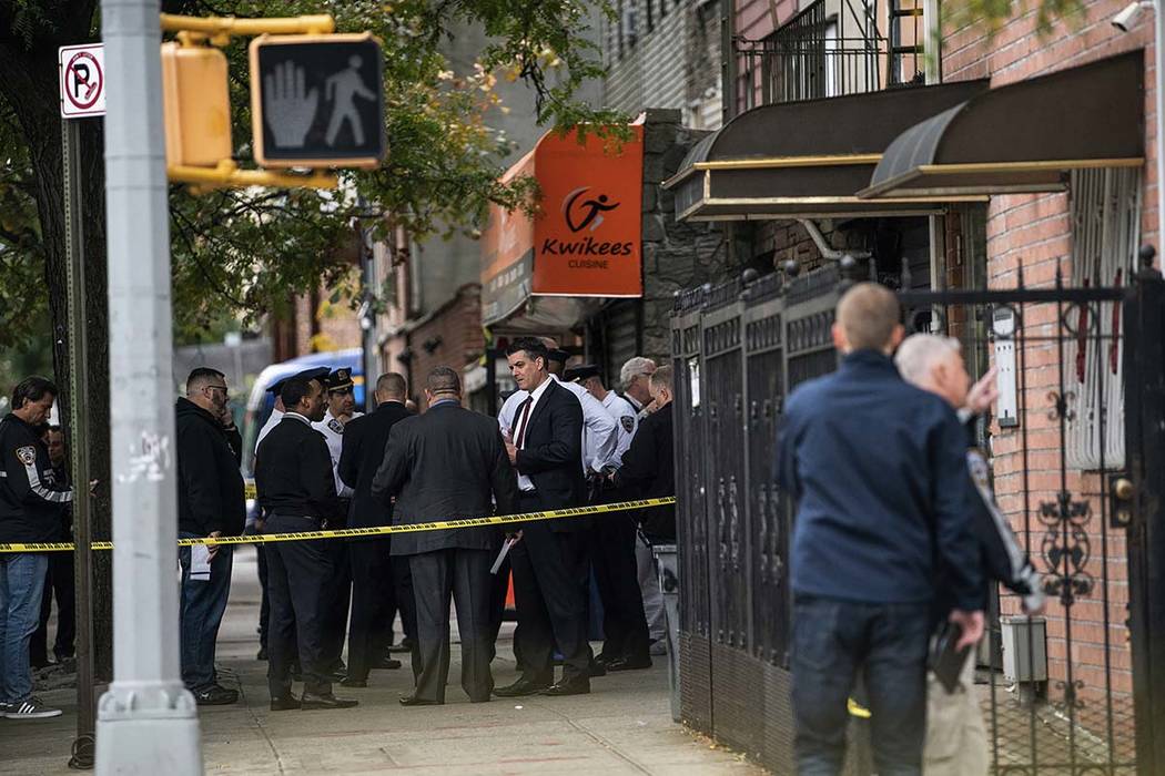 NYPD investigates the scene of a shooting in the Brooklyn borough of New York on Saturday, Oct. ...