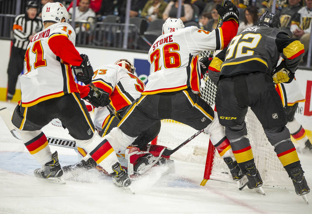 Vegas Golden Knights left wing Tomas Nosek (92) sneaks a goal in behind Calgary Flames goaltend ...