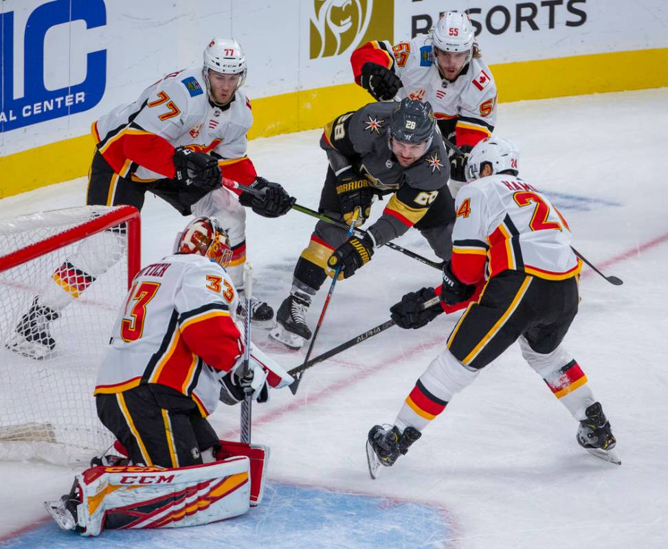 Vegas Golden Knights left wing William Carrier (28) penetrates the defense and shoots on Calgar ...