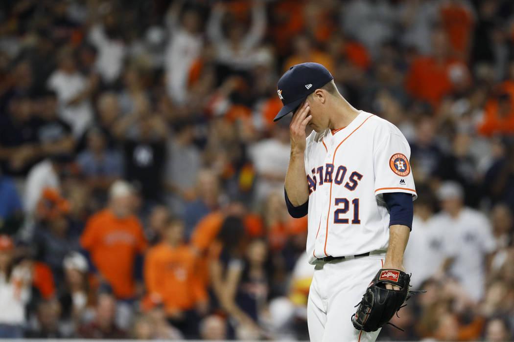 Houston Astros starting pitcher Zack Greinke reacts after giving up a home run to New York Yank ...