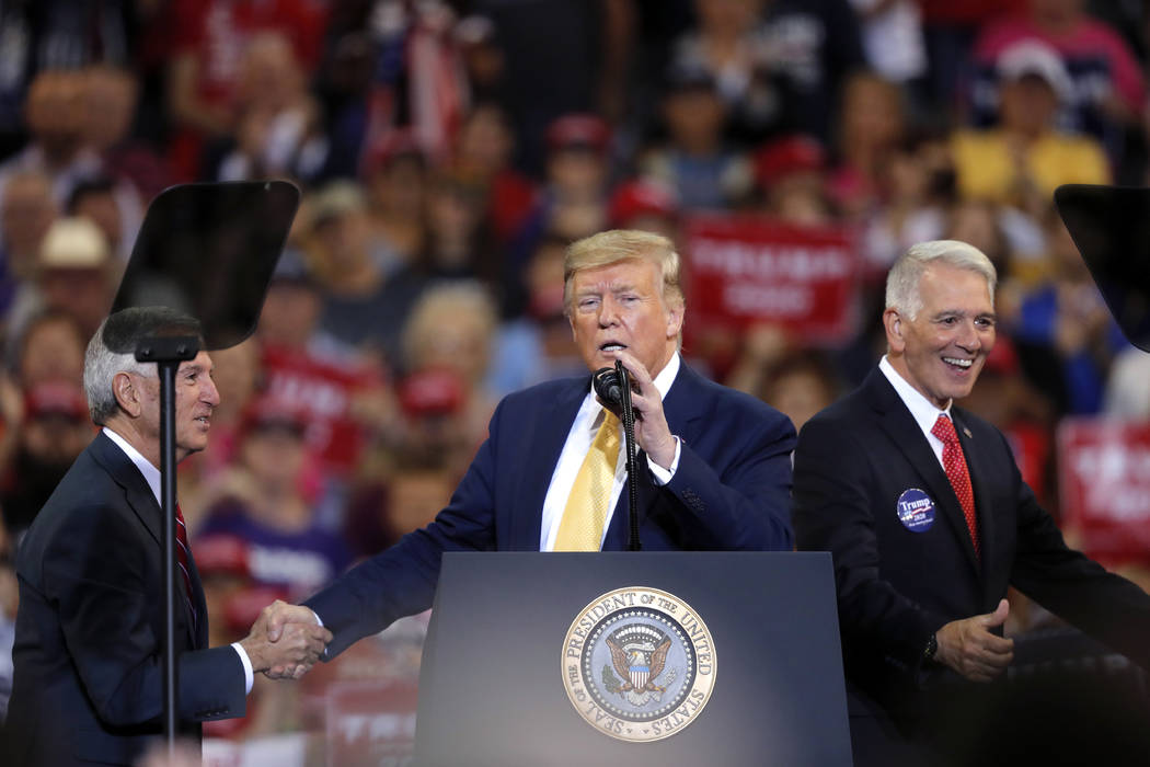 President Donald Trump greets Louisiana Republican gubernatorial candidates Ralph Abraham right ...