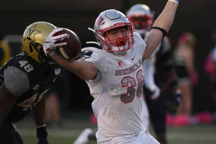 UNLV running back Chad Maygar, right, celebrates a touchdown past Vanderbilt linebacker Andre M ...