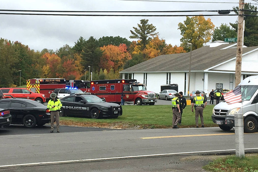 In this photo provided by WMUR-TV, police stand outside the New England Pentecostal Church afte ...