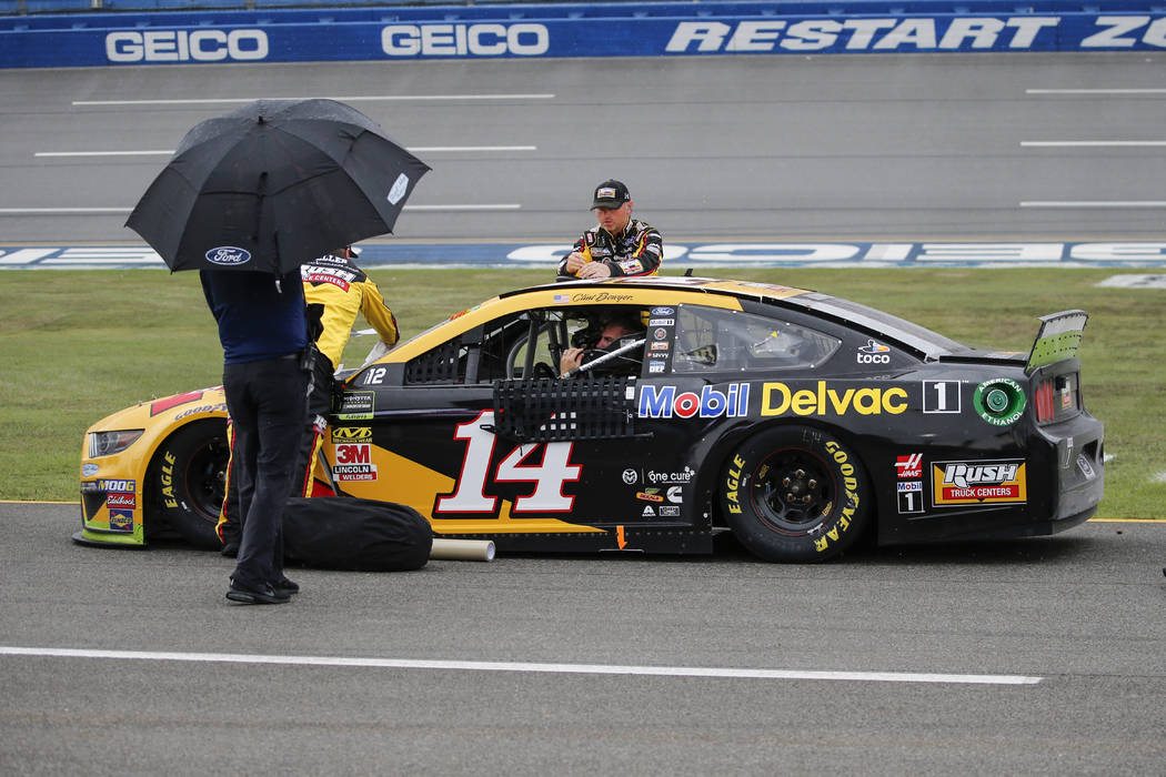 Clint Bowyer (14) sits in his car during a rain delay in a NASCAR Cup Series auto race at Talla ...
