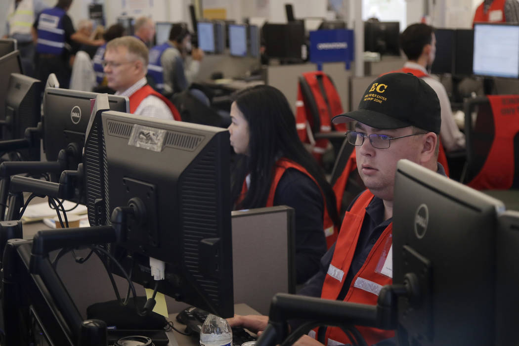 In an Oct. 10, 2019, file photo, Pacific Gas & Electric employees work in the PG&E Emergency Op ...