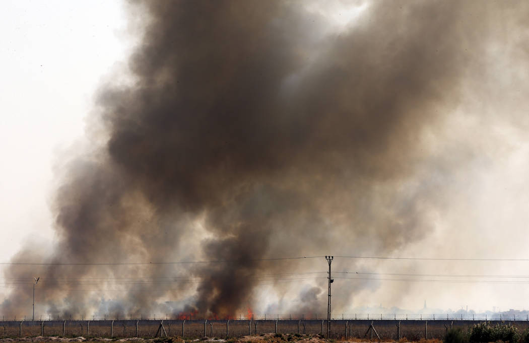 In this photo taken from the Turkish side of the border between Turkey and Syria, in Akcakale, ...