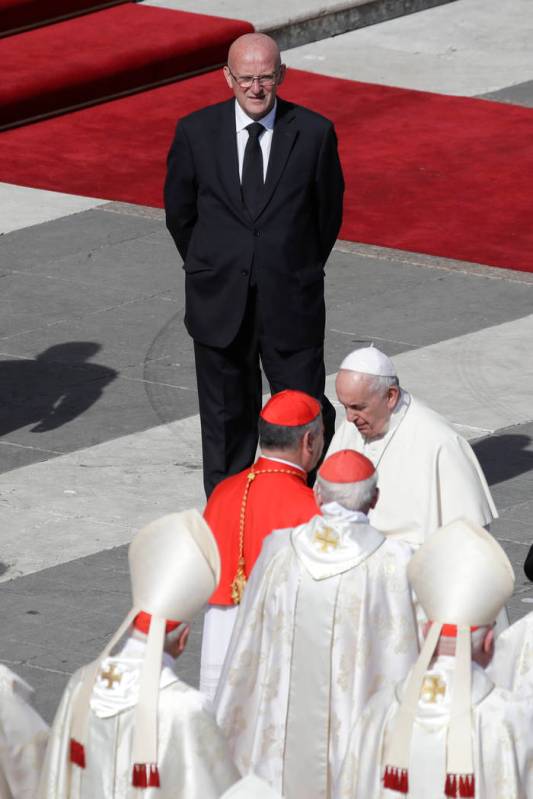 Vatican head of security Domenico Giani, top, looks at Pope Francis at the end of a canonizatio ...