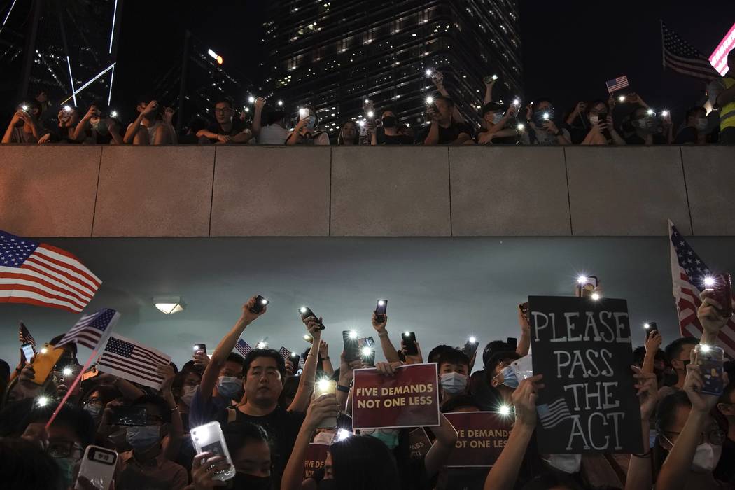 Protestors light their torches during a peaceful rally in central Hong Kong's business district ...