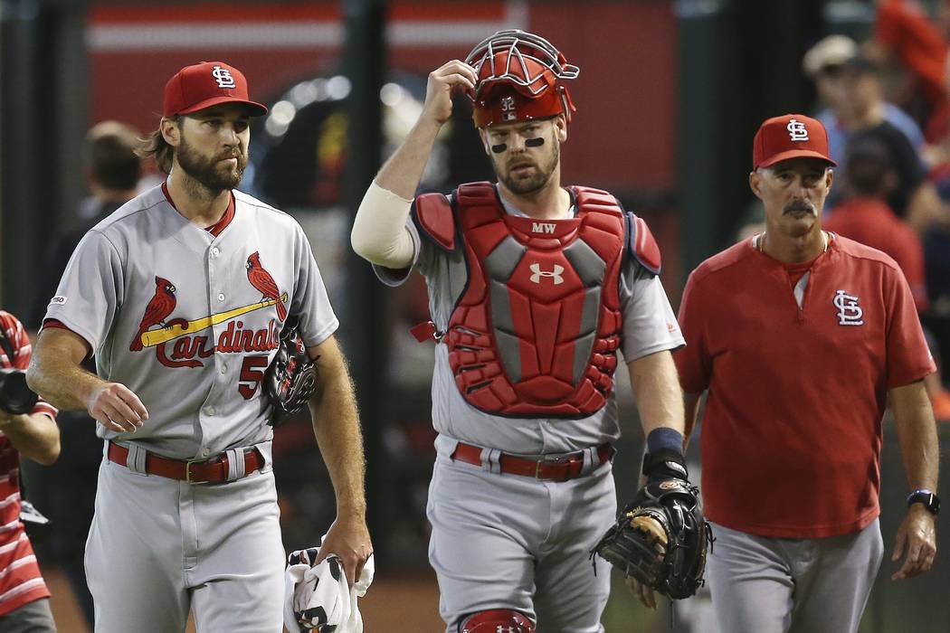 St. Louis Cardinals starting pitcher Michael Wacha, left, catcher Matt Wieters, middle, and pit ...