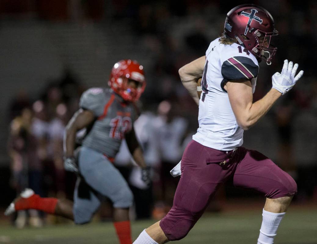 Faith Lutheran senior wide receiver Peyton Thornton (14) makes a big catch and run past an Arbo ...