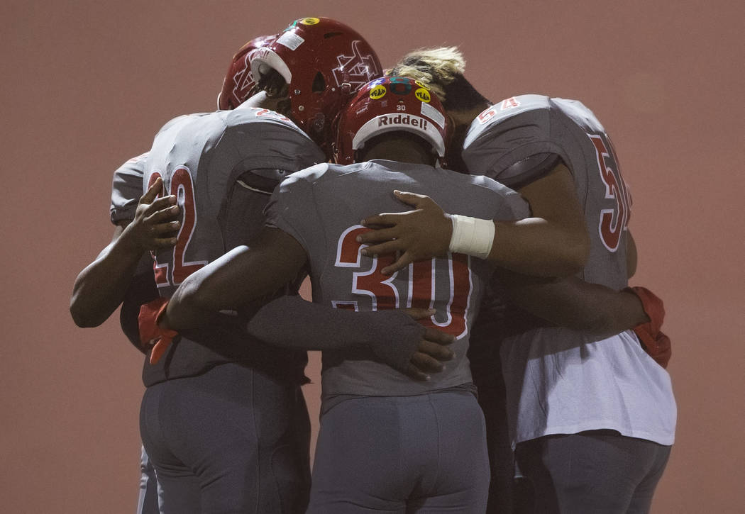 Arbor View senior running back Darius Williams (30) prays with teammates before the start of th ...