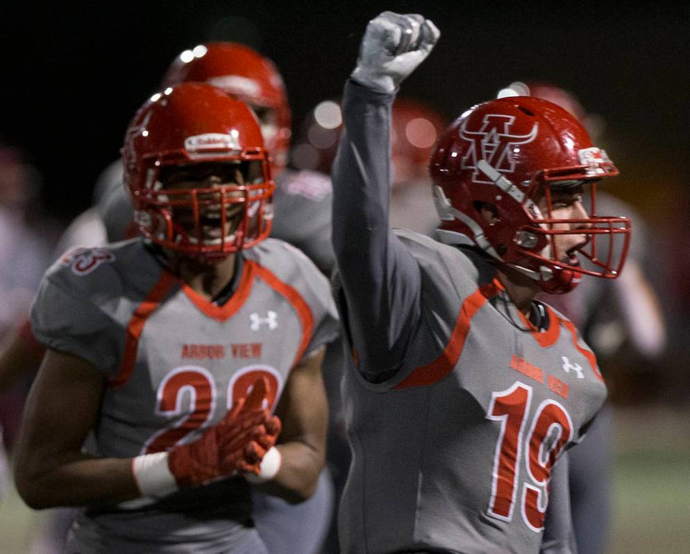 Arbor View senior defensive back Nolan Weir (19) celebrates with teammates after a big defensiv ...