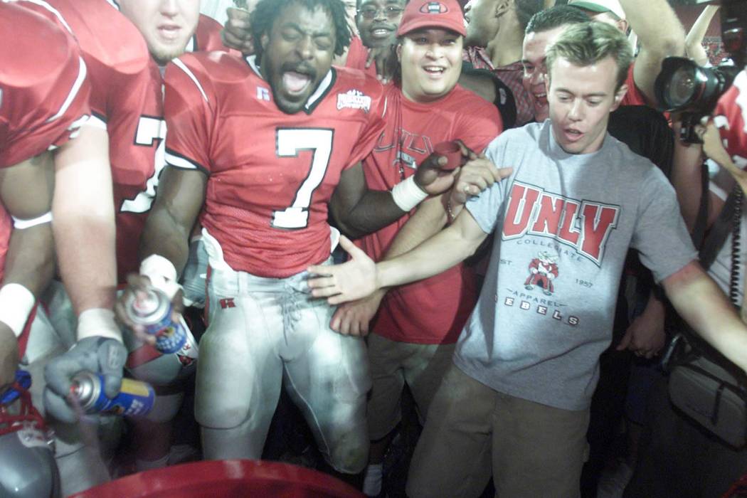 Sports; 10-07-00, UNLV#7 Jeremi Rudolph spray paints the Fremont Cannon after the Rebels victo ...
