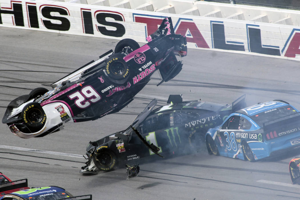 Brendan Gaughan (62) flips in Turn 3 as driver Kurt Busch (1) and David Ragan (38) pass underne ...