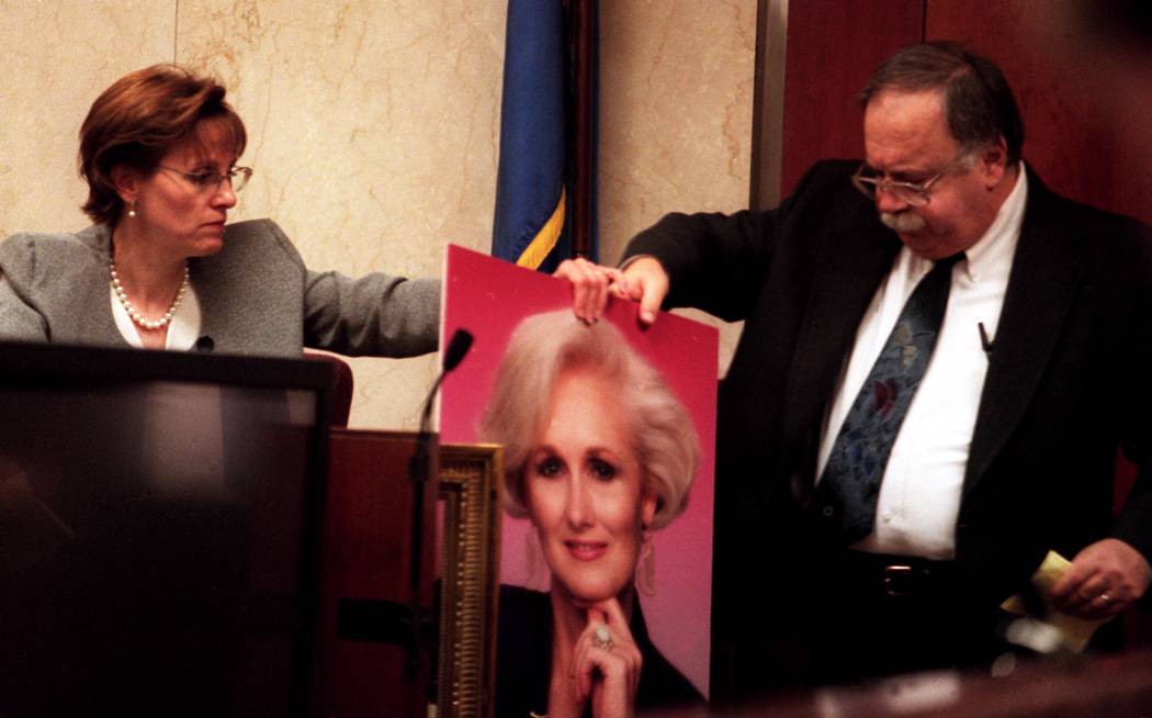 Linda Erechetta and attorney Tom Pitaro discuss blood marks while holding a portrait of Margare ...