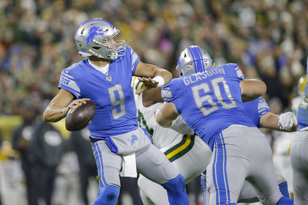 Detroit Lions quarterback Matthew Stafford drops back to pass during the first half of an NFL f ...