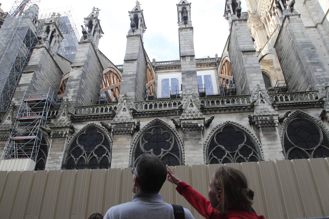 People walk by Notre Dame cathedral Tuesday, Oct. 15, 2019 in Paris. French Culture Minister Fr ...