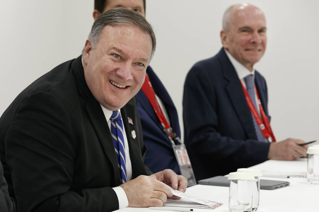 FILE - In this June 28, 2019, file photo, Secretary of State Mike Pompeo, left, sits down for a ...