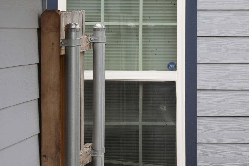 A bullet hole could be seen in the back window outside the Fort Worth home Monday, Oct. 14, 201 ...