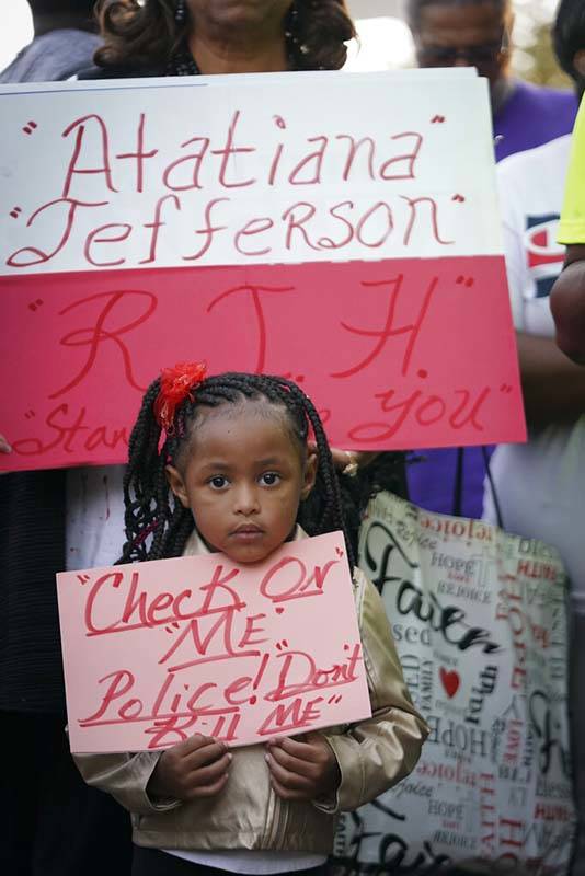 Trinity Ford, 4, joins the crowd gathered during a community vigil for Atatiana Jefferson on Su ...
