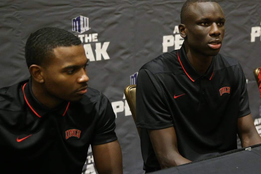 UNLV players from left, Amauri Hardy, Cheikh Mbacke Diong, and head coach T. J. Otzelberger, pa ...