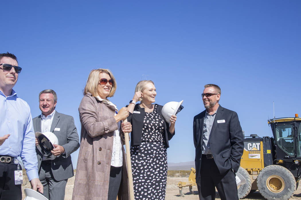 Individuals representing Lennar, Shea Homes and Woodside Homes celebrate the ground breaking of ...