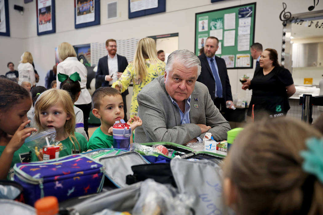 Gov. Steve Sisolak has lunch with Cade Christafaris, 5, from left, and Elizabeth Belger, 5, at ...