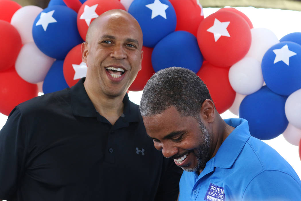 Democratic presidential candidate Sen. Cory Booker, D-N.J., left, shares a laugh after being in ...