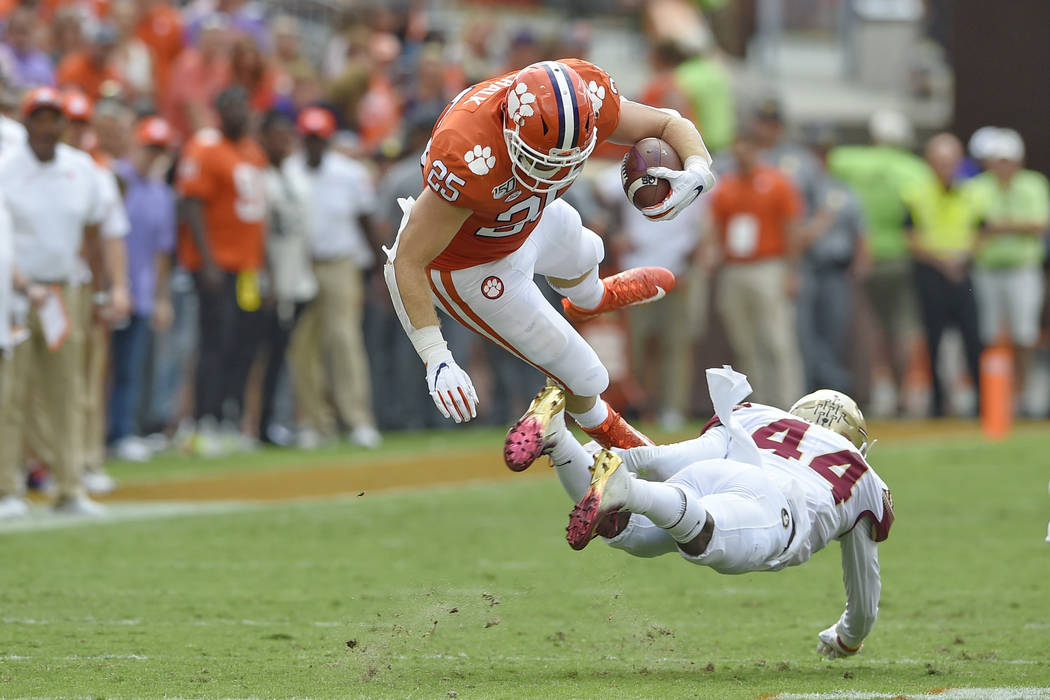 Clemson's J.C. Chalk (25) is upended by Florida State's Brendan Gant during the first half of a ...