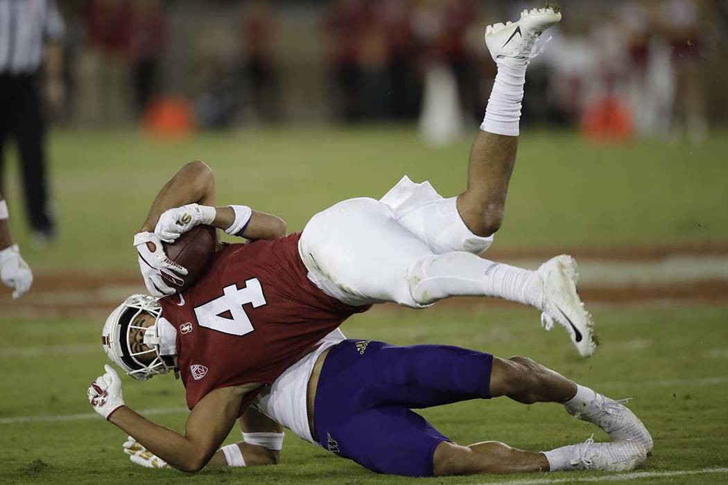 Washington's Trent McDuffie tackles Stanford's Michael Wilson (4) during the second half of an ...