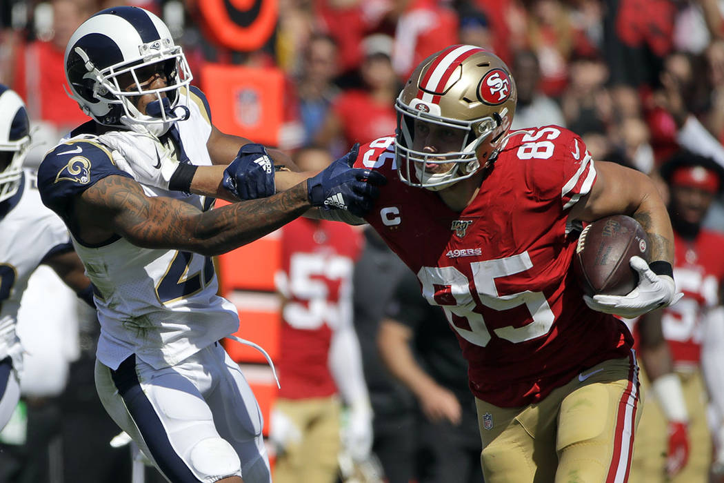 San Francisco 49ers tight end George Kittle (85) stiff-arms Los Angeles Rams cornerback Marcus ...