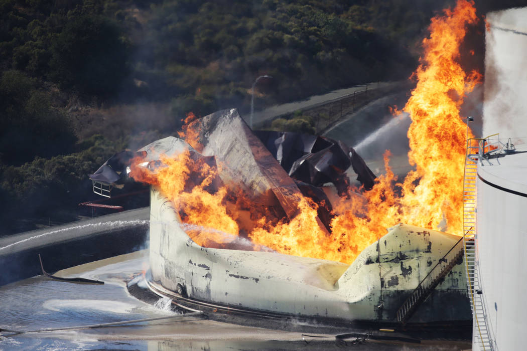 A tank burns as fire breaks out at a refinery in Crockett, Calif., on Tuesday, Oct. 15, 2019. A ...