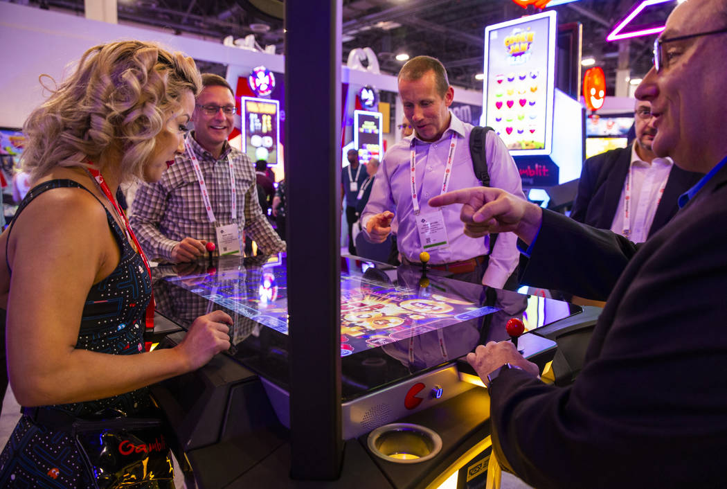 Attendees play PAC-MAN Battle Casino in the Gamblit Gaming exhibition space during the Global G ...