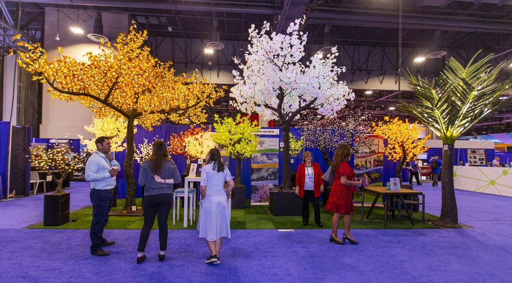 Attendees enjoy some conversation on the Illuminated Trees and Lenasi Furniture exhibition floo ...