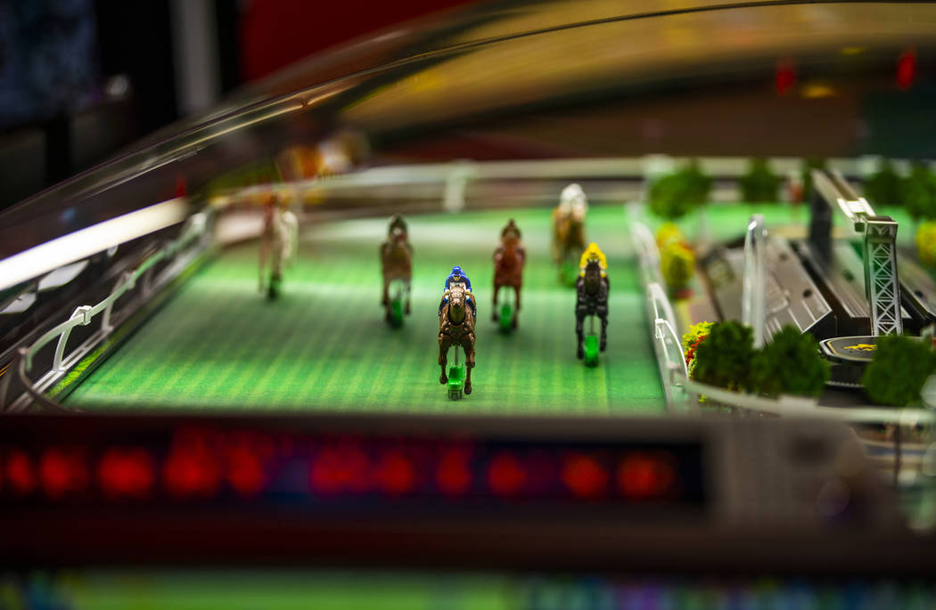 Horses make their way along the track in the Fortune Cup Derby Deluxe game by Konami Gaming dur ...