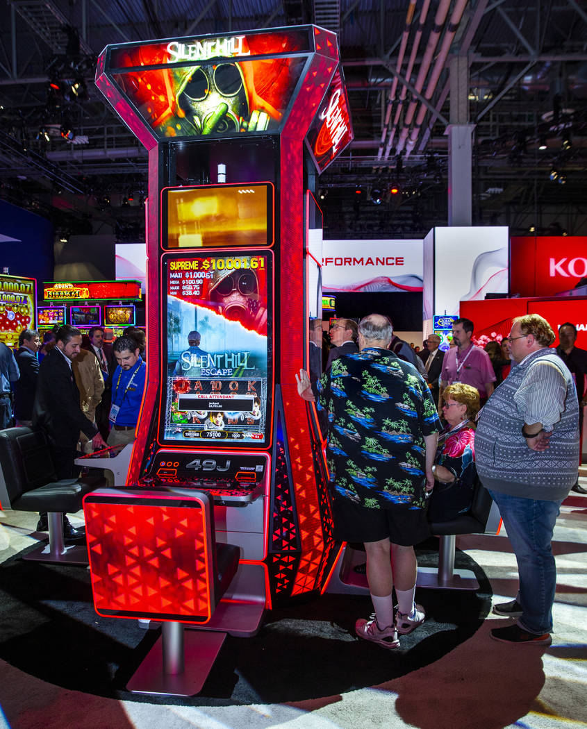 Attendees play the new Silent Hill slot game by Konami Gaming during the Global Gaming Expo 201 ...