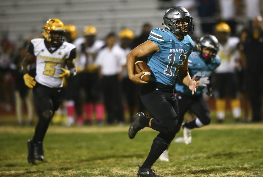 Silverado's Jacob Mendez (12) runs the ball on the way to scoring a touchdown against Clark dur ...