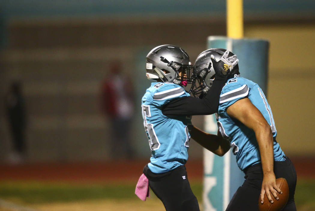 Silverado's Jeremy Alipio, left, celebrates a touchdown by Jacob Mendez during the first half o ...