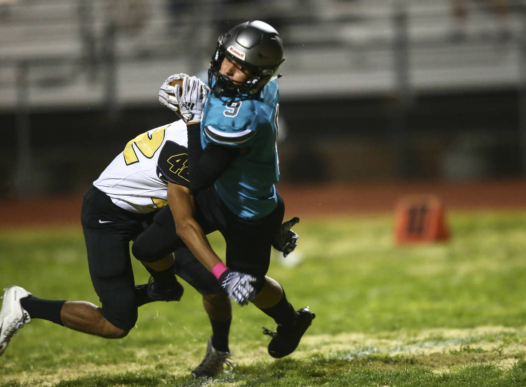 Silverado's Bryson Tunnell (9) makes the catch to score a touchdown as Clark's Sunil Shaw (42) ...