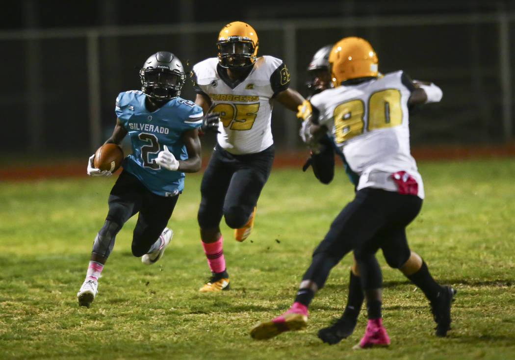 Silverado's Aginae Cunningham (2) runs the ball against Clark during the first half of a footba ...