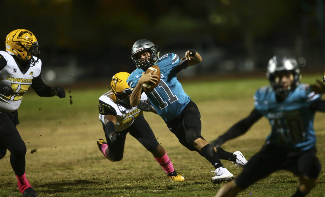 Silverado's Brandon Tunnell (11) runs the ball past Clark's Kameran Cason (85) during the secon ...