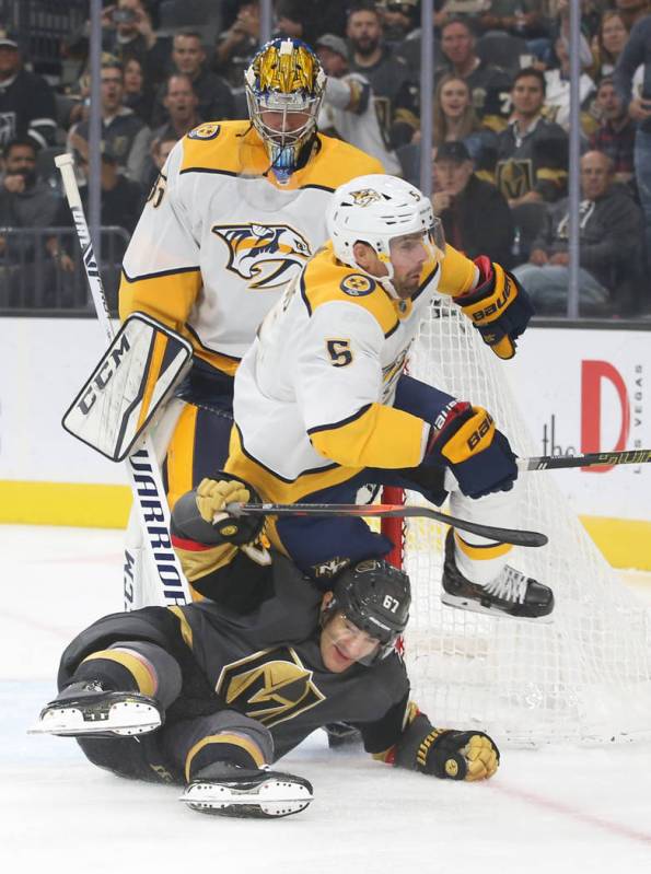 Vegas Golden Knights left wing Max Pacioretty (67) slides under Nashville Predators defenseman ...