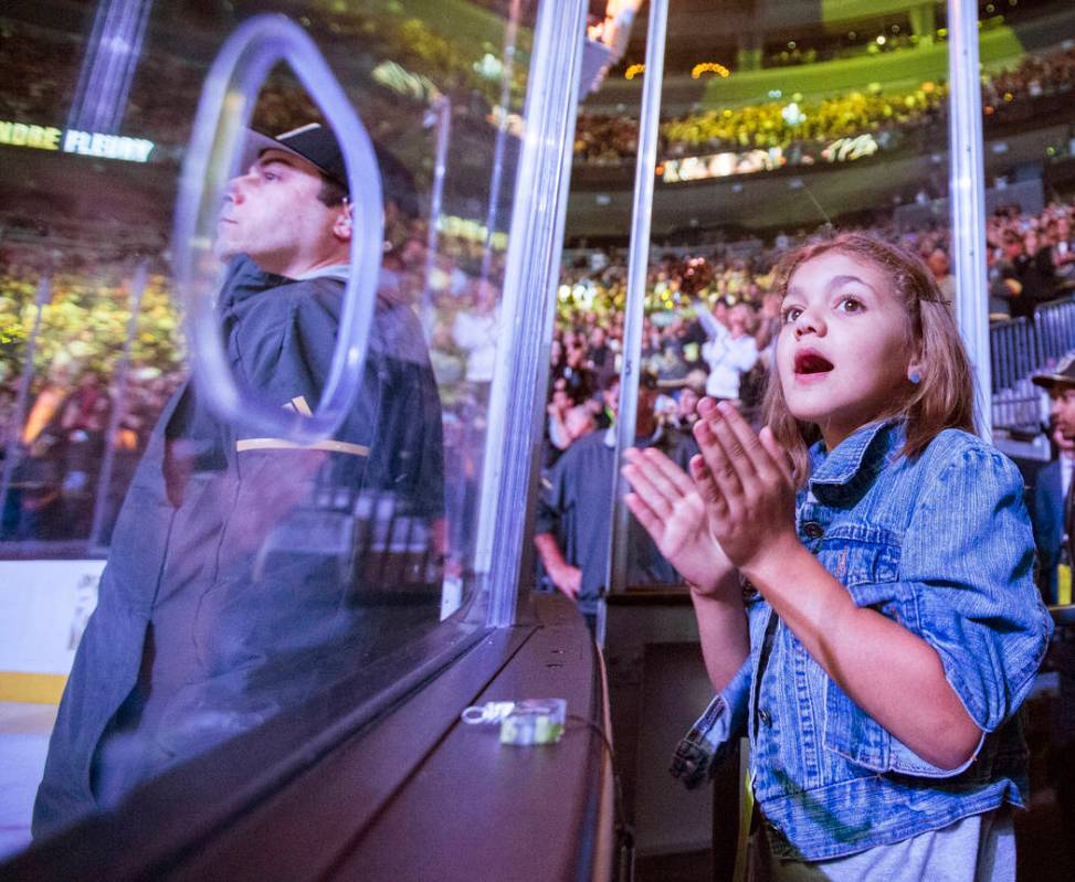 A Golden Knights fan cheers during the first period of Vegas' NHL hockey game with the Nashvill ...