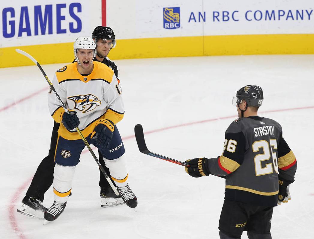 Nashville Predators center Nick Bonino (13) celebrates in front of Vegas Golden Knights center ...