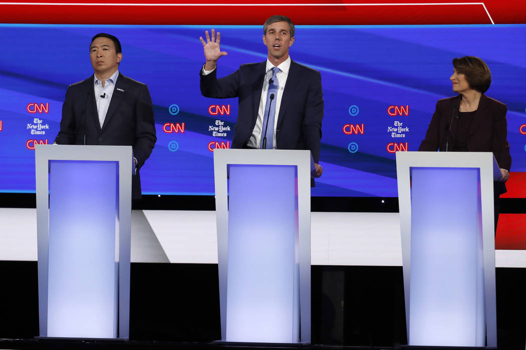 Democratic presidential candidate entrepreneur Andrew Yang, left, former Texas Rep. Beto O'Rour ...