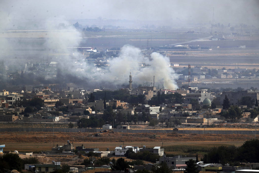 In this photo taken from the Turkish side of the border between Turkey and Syria, in Ceylanpina ...