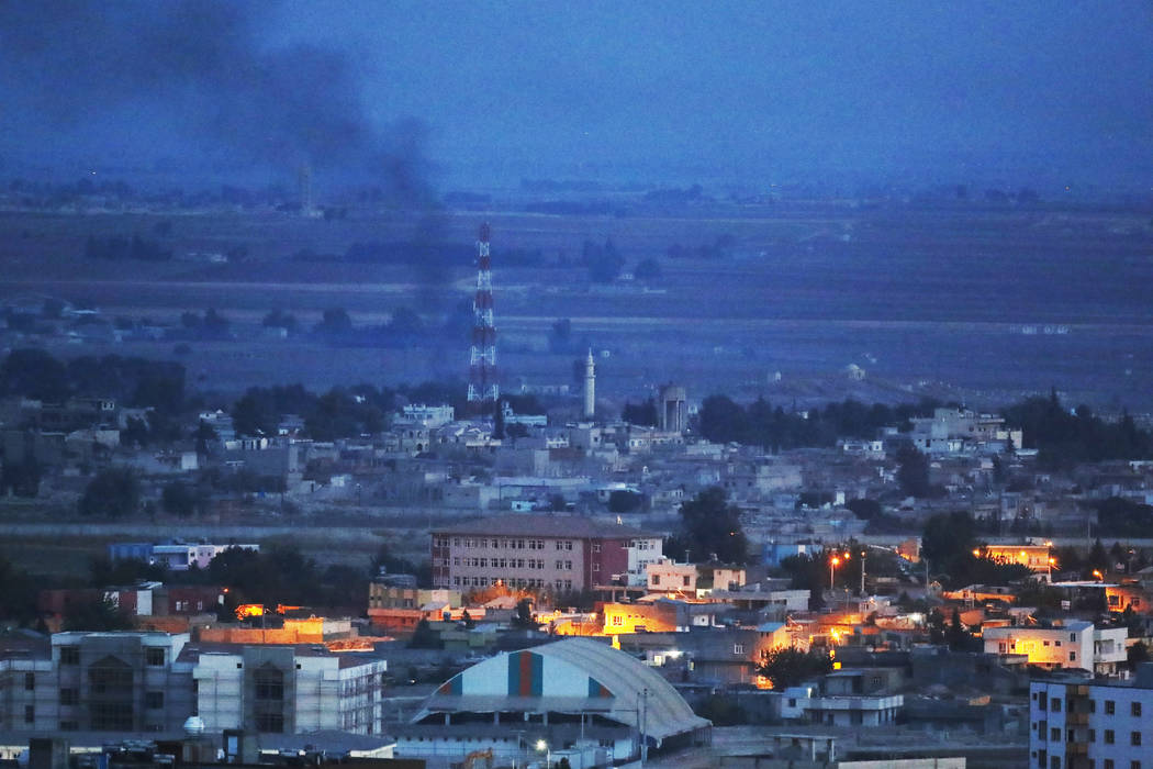 In this photo taken from the Turkish side of the border between Turkey and Syria, in Ceylanpina ...