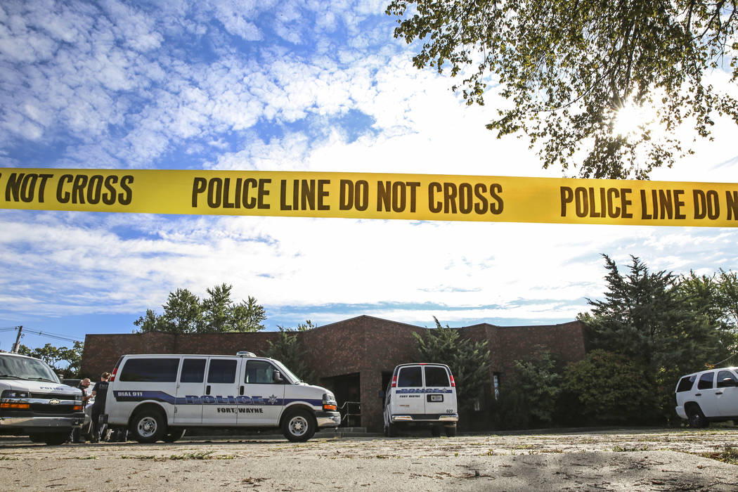 Officers from the Fort Wayne Police Department search the building that once housed an abortion ...